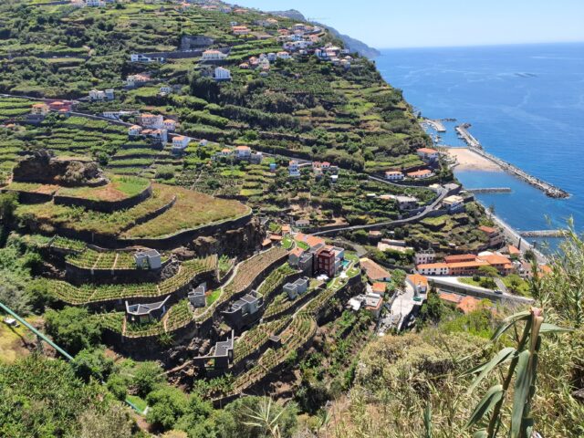 Aerial View of a Lush Terraced Valley – A stunning top-down view of green terraces cascading down the hillside.