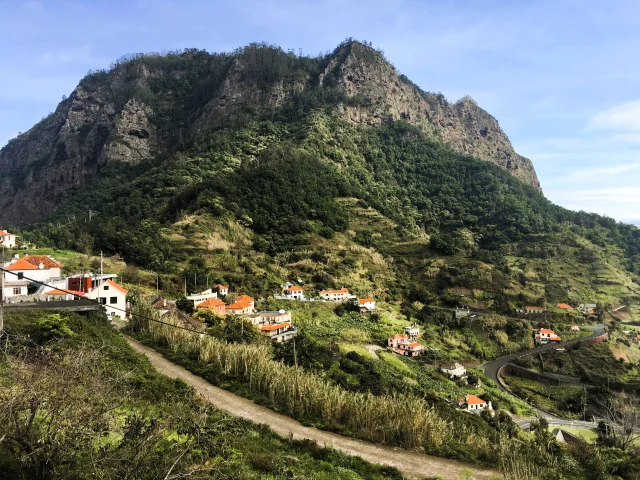 Dramatic mountain backdrop and terraced farmland along the Levada do Castelejo walking route.