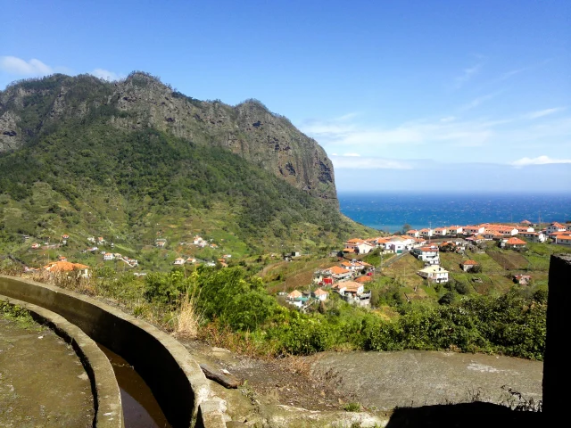 Coastal view from Levada do Castelejo with Penha d’Águia and Porto da Cruz village by the Atlantic Ocean.