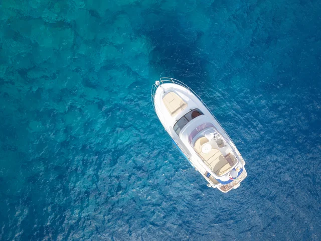 Aerial shot of the luxury yacht cruising in crystal-clear Atlantic waters