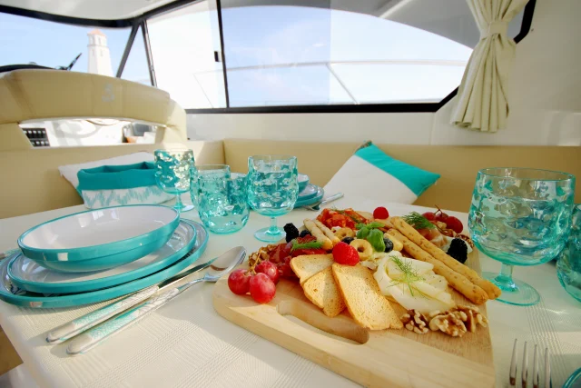 Table with gourmet snacks and drinks served onboard the luxury yacht