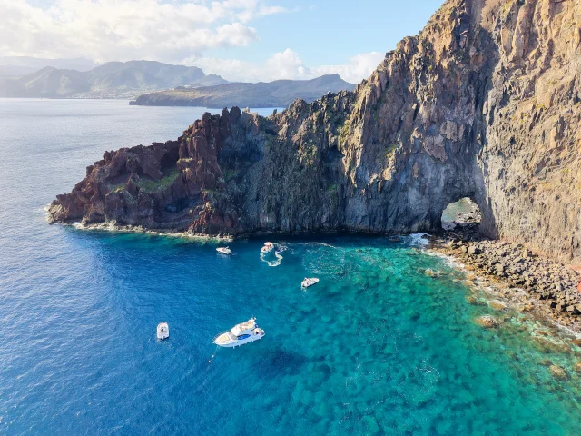 Aerial view of the luxury yacht sailing near the cliffs of Madeira