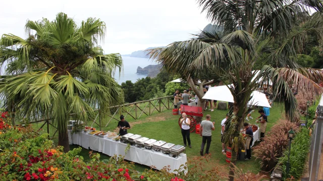 Traditional Madeiran buffet served in a garden with sea views during the Wine Harvest Tour.
