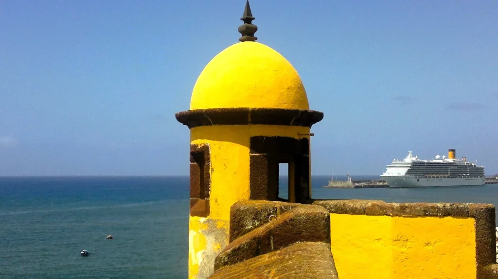 Things to do in Funchal from cruise port – Forte de São Tiago in the Old Town with cruise ship in Madeira harbour.