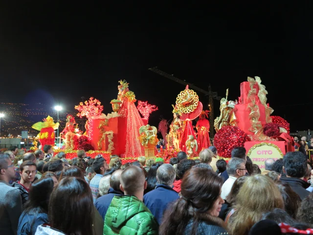 Group of Carnival performers dressed in red costumes during the Madeira Carnival Parade
