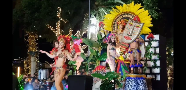 Carnival performers and colourful floats passing through Avenida do Mar during the Madeira Carnival Parade